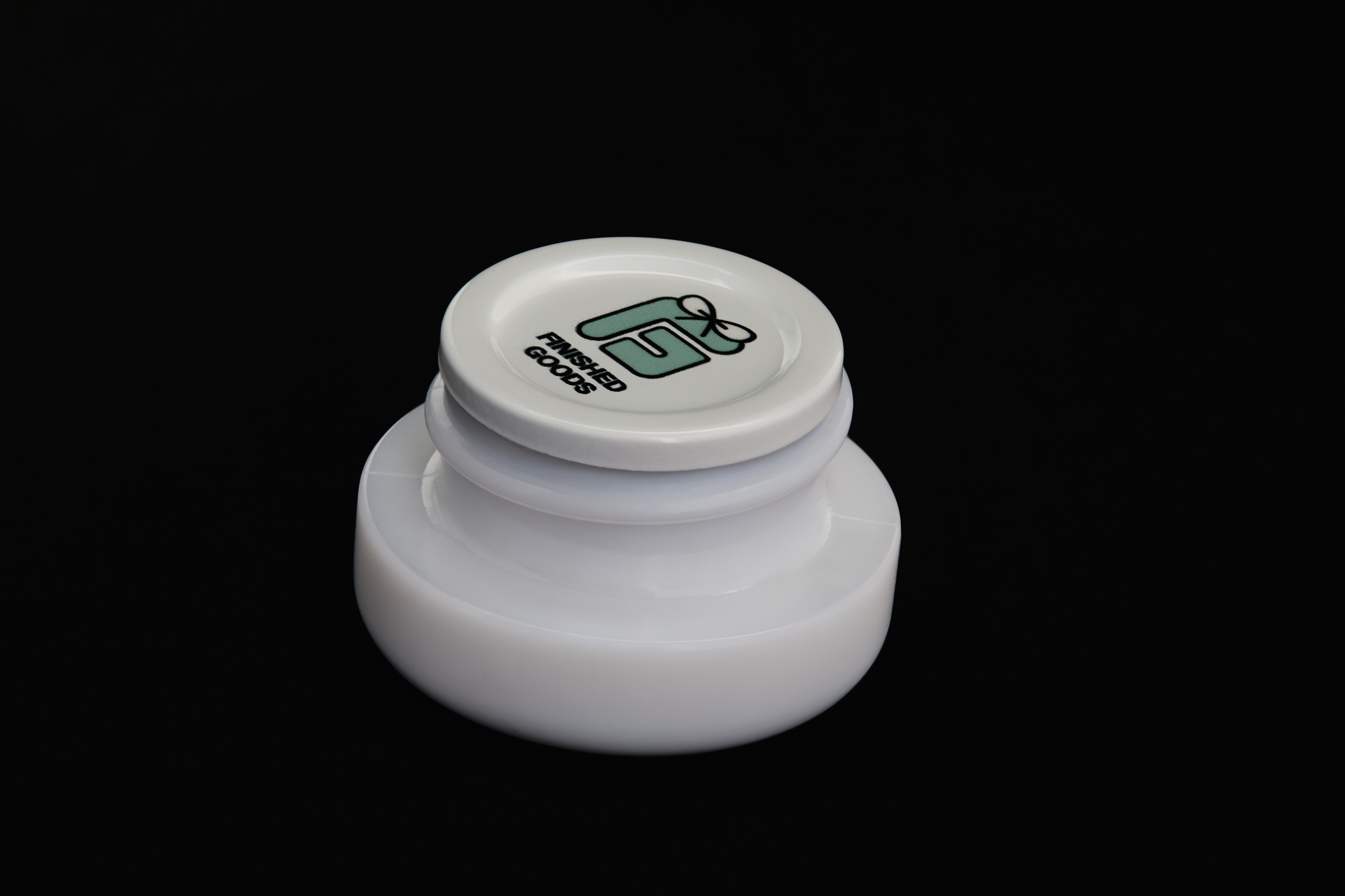 White concentrate jar with lid partially lifted