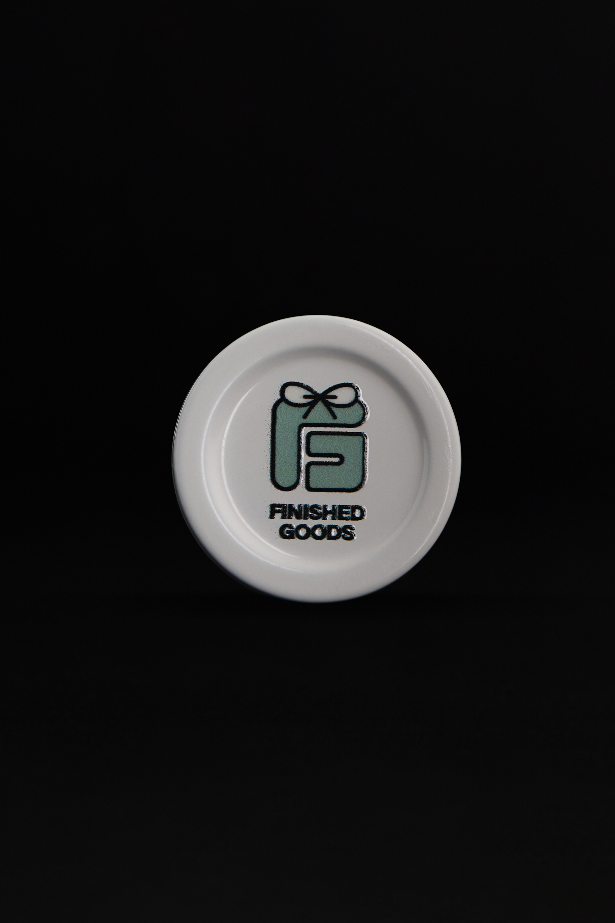 White jar lid with FG logo from above